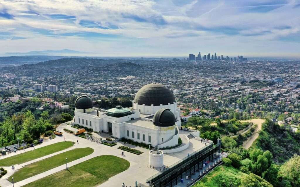 Griffith Observatory from above with downtown Los Angeles in the distance